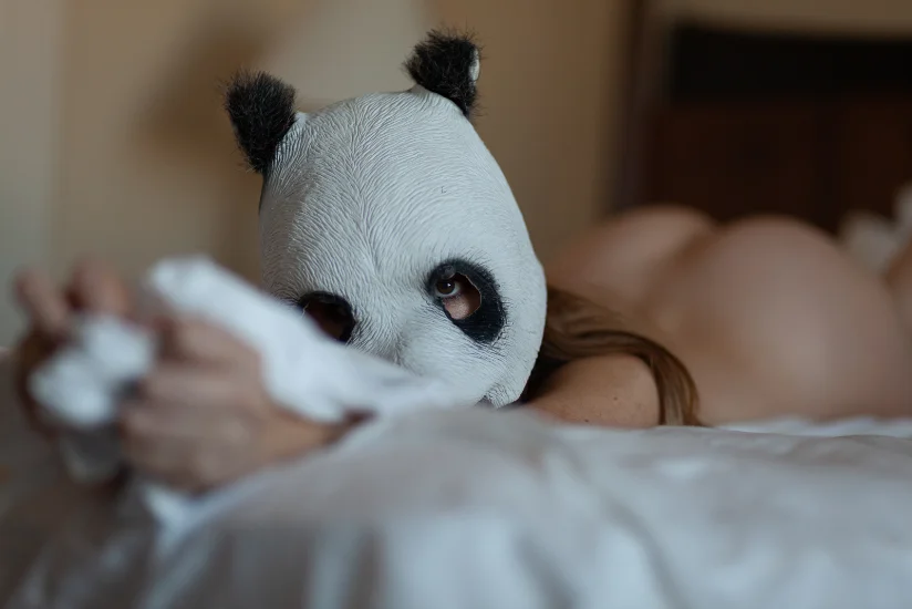 PNDAGRLS — panda mask resting on white bedding, CRZYPNDA photography
