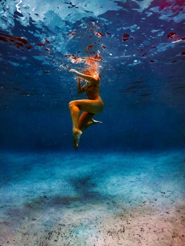 Figure suspended in deep blue ocean water — CRZYPNDA underwater photography