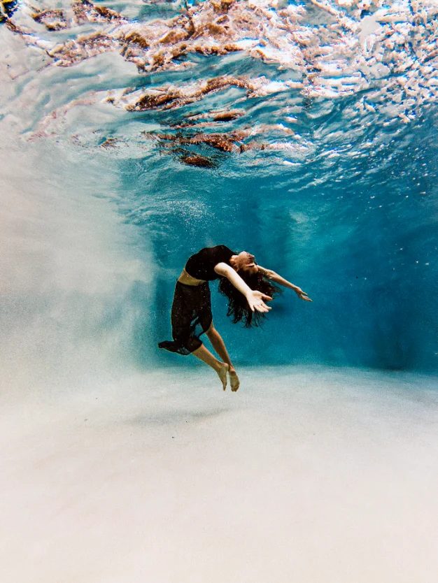 Underwater photograph of a dancer floating in a black dress — CRZYPNDA